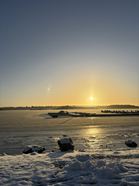 A low winter sun over an icy fjord in Norway. 