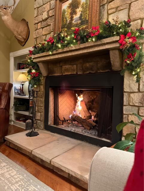 A second fireplace, also decorated with wreaths and holly 