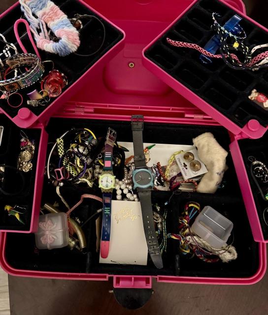 An old hot pink caboodle with 80s or 90s watches & assorted items.