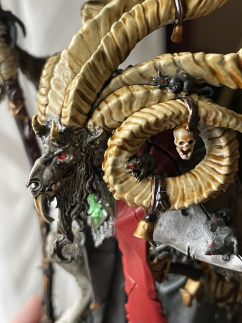 A close-up of his head and horns from the left. 