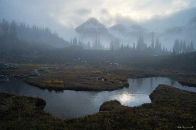 A quiet moment, wrapped in mist and softened by the fading light. This alpine landscape shifts with the mood of the atmosphere—clouds weaving through jagged peaks, evergreen silhouettes fading in and out of view. A tarn, ever so slightly waving in the breeze, mirrors the luminosity of the sky.

'Witches Lair' (2023)