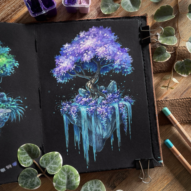 A photo of an open black paper sketchbook placed on a wooden table and surrounded by small paint tubs, coloured pencils, and leaves for decoration. The open page features a tree with lavender foliage on a seemingly floating chunk of rock, turquoise water spilling over its edges. At the base of the tree purple foliage is growing, and a few small rocks point upwards. Little glowing lights surround them.