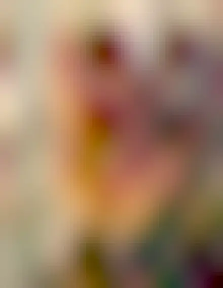 An Isa Brown hen, taken from slightly above. She has golden brown feathers and is looking toward the camera with her left eye, head turned. One foot can be seen under her chest, elegantly forward like a supermodel might pose. 