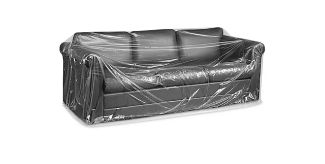 A couch, but wrapped in plastic.