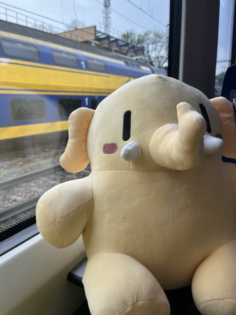 Plushtodon with a yellow train in the back 