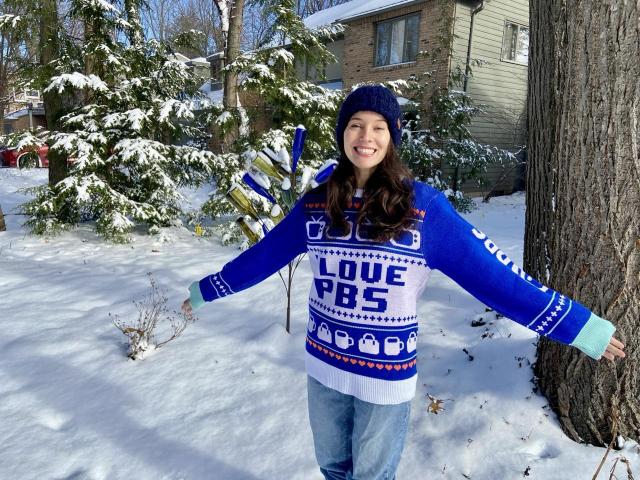 Me wearing a sweater that says “I Love PBS”