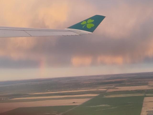 Wing fin of Aer Lingus plane with a faint rainbow underneath