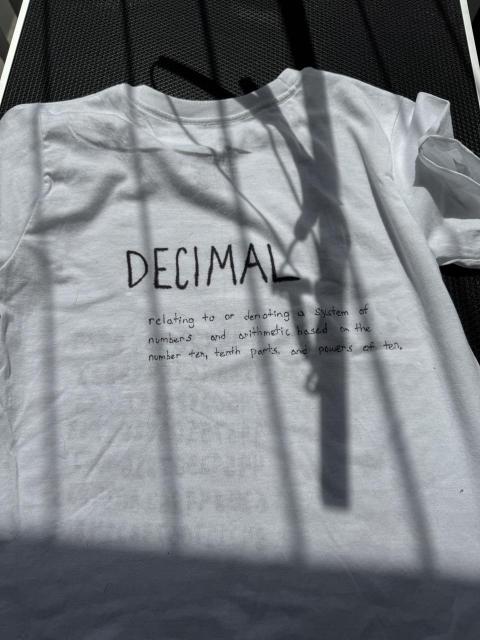 A white tshirt with the definition of decimal on the back