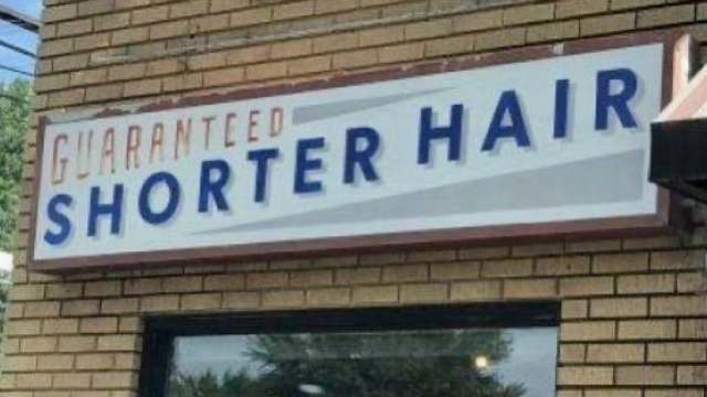 Salon sign reads “Guaranteed Shorter Hair.”