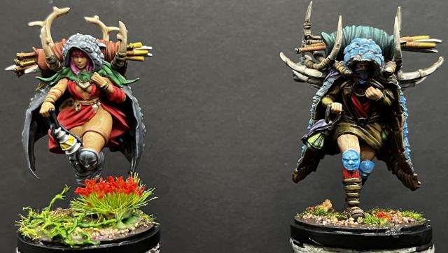 Front view of female (left) & male (right) painted miniatures.