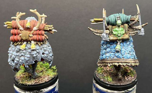 Back view of female (left) & male (right) painted miniatures.