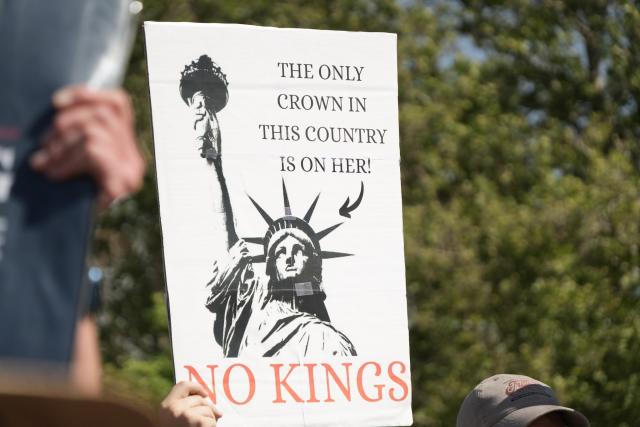 The only crown in this country is on her (arrow points to the Statue of Liberty)