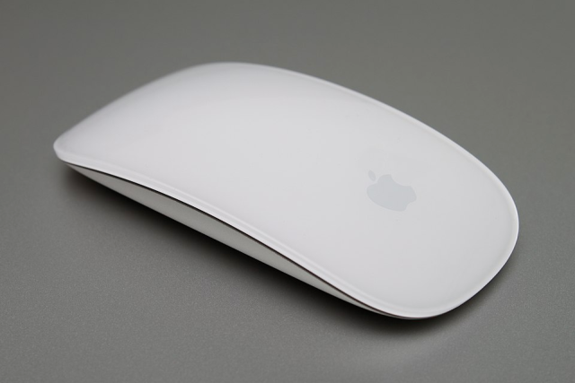 the apple magic mouse. it's a smooth, featureless glass slab. no separate physical buttons, no scroll wheel. it has a very low profile.