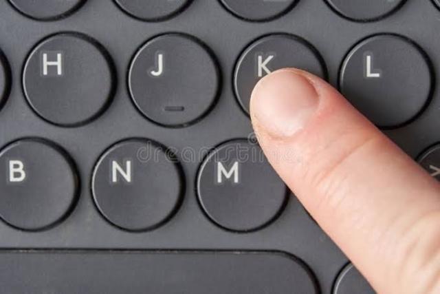 finger pressing K on a keyboard