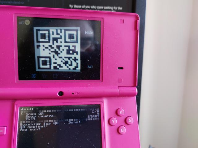 Spoiler for game: DSi pointing at screen running dsidl to view QR code