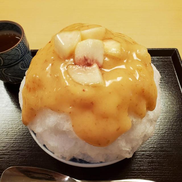 Peach kakigori...shaved ice covered in thick peach syrup and slices of fresh peach.