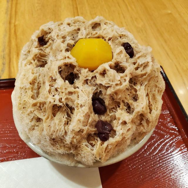 Dark sugar flavoured kakigori, with slices of chestnut buried in the ice.
