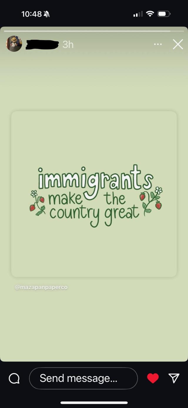 A flowery message saying, "Immigrants make the country great" in white text on a pale green background, with flowers around the words.