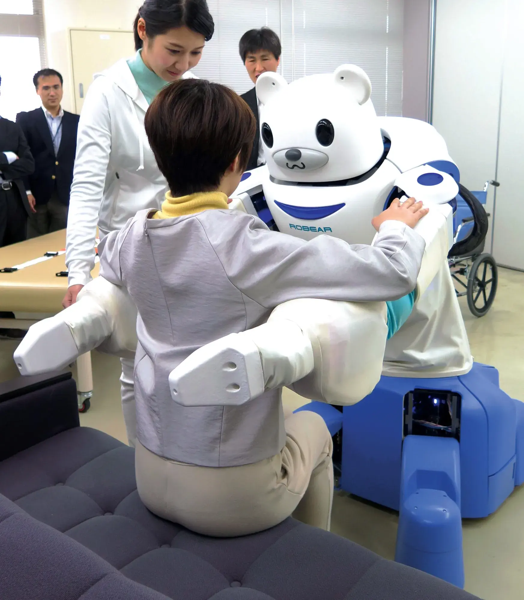 Staff member is demonstrating an eldercare robot.