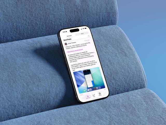 Image of an iPhone sitting on a couch and with the app's feed opened.