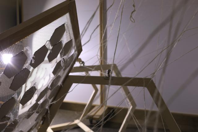 A detail of the same artwork showing the sculptural pieces from behind