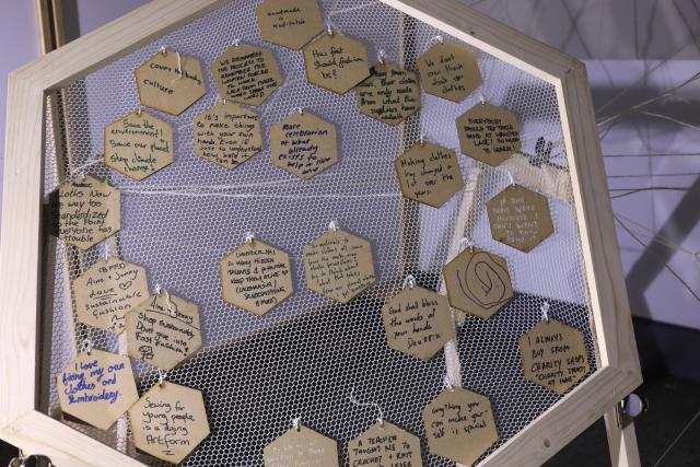 A close up of the sculptural piece with many hand-written texts visible. Each is a response by a visitor to a socially engaged artwork about the entanglement of technology, history, climate and clothing.