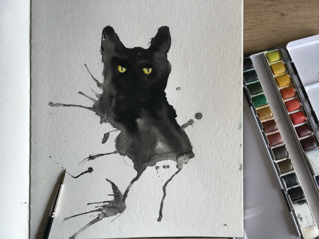 An ink blot that looked  like a cat for two cat eyes 