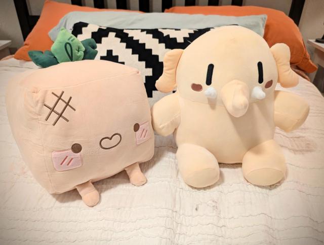 Big cubified Turnip Boy plushie next to Plushtodon, the Mastodon plushie
