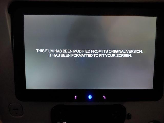 a photo of the in-flight entertainment screen on an Airbus A380. it is displaying text that reads as follows: THIS FILM HAS BEEN MODIFIED FROM ITS ORIGINAL VERSION. IT HAS BEEN FORMATTED TO FIT YOUR SCREEN.