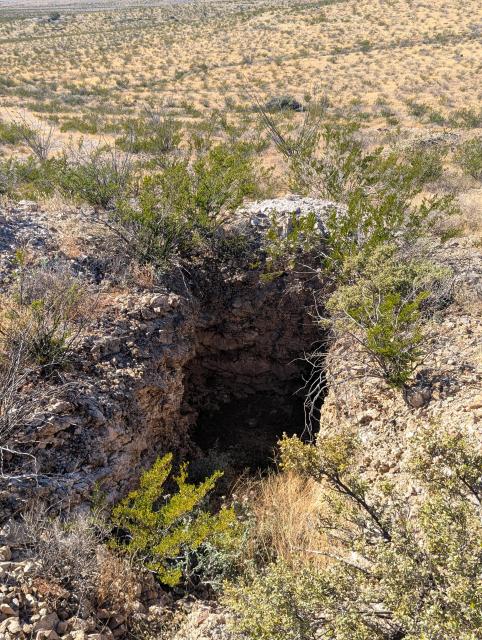 A smaller rectangular mine shaft at a different location in the desert, this one has not been sealed off with a metal grate and poses a bit of a safety hazard. 