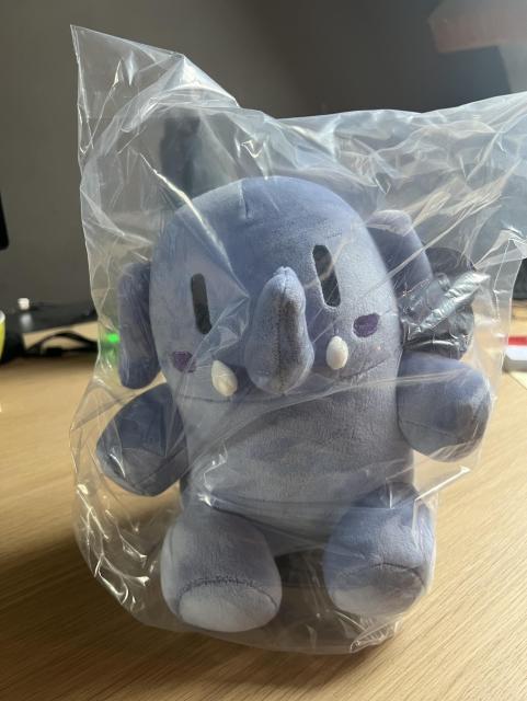 The mastodon small blue plushie, wrapped in plastic