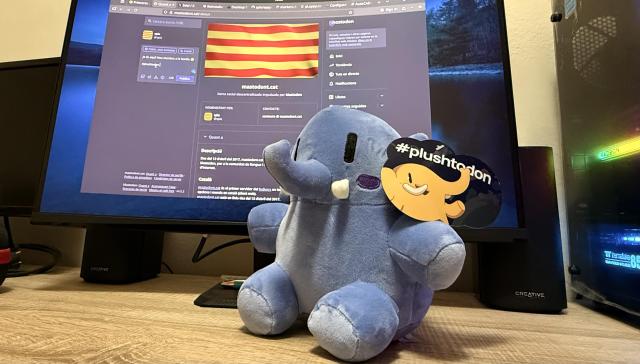 Peluix de Mastodon, Plushtodon, davant del monitor on es veu la pàgina de mastodont.cat