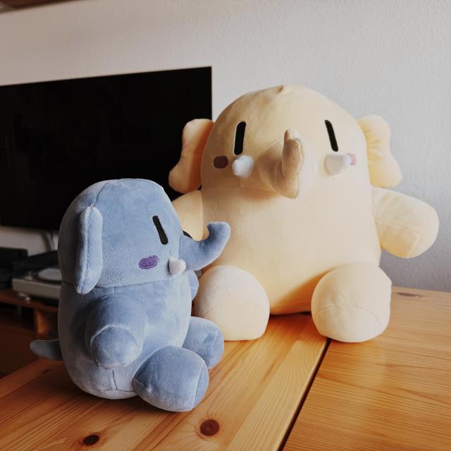 The big original mastodon plush with the blue, smaller mastodon plushie next to it. 