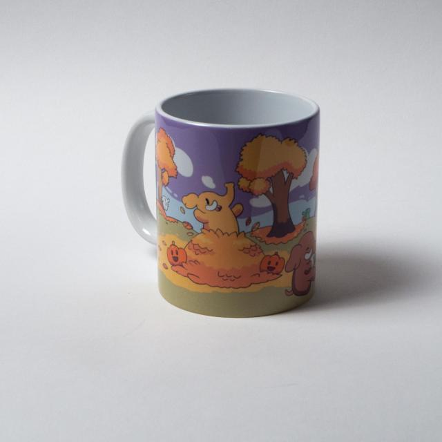 The same mug from a different angle, in which you can see a Mastodon emerging from a pile of leaves, as well as some happy pumpkins.