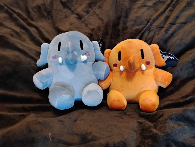 Image of the smaller Blue and Orange Plushtodon's resting on a giant bean bag.