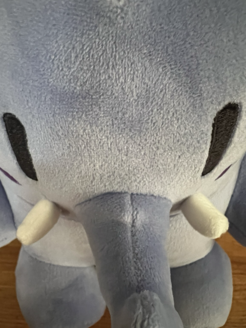 A blue Mastodon Elephant Plushie, photographed from above. Their Forehead looks way bigger than it actually is