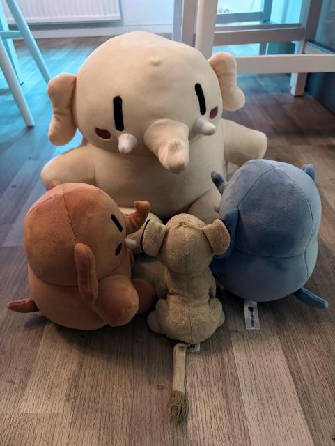 Three mastodons and a lion sitting in a circle