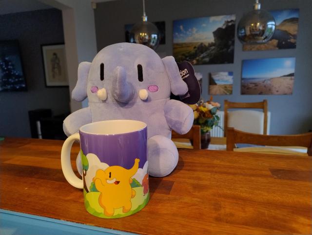 Mastodon plushie toy with matching coffee mug.