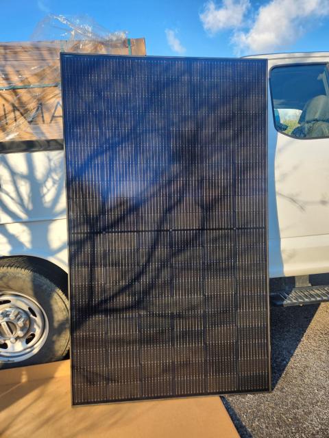 A solar panel leaning against a car