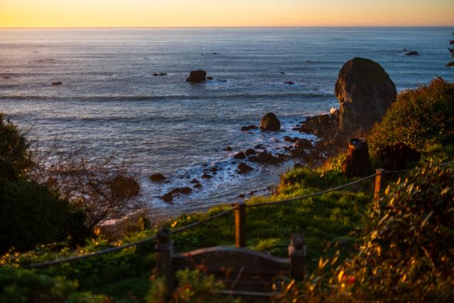 A sunset view from the coast, looking over rocks in the distance. [Fuji X-T5 / Fuji 35 1.4]