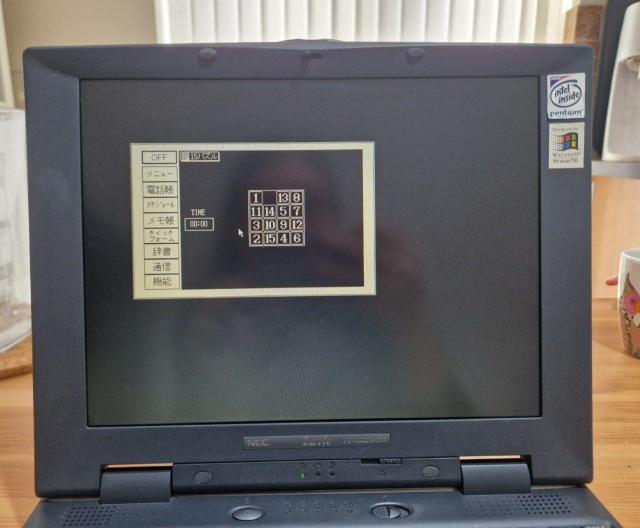 A photo of an old laptop. The screen shows a full-screen emulation of Casio Caleid organiser, running a simple puzzle game
