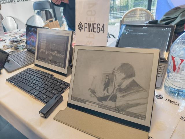 PineNote demo devices running Doom and playing aha's take on me.
