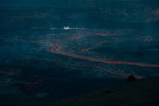 Bright orange lava flows cut through blue dusk. [Fuji X-T5 / Tamron 18-300]