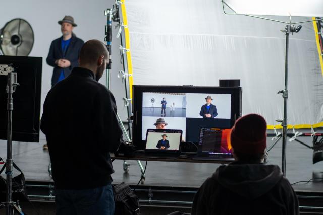 Photo from Nextcloud Hub 26 Winter presentation backstage: crew with screen and presenter on the stage