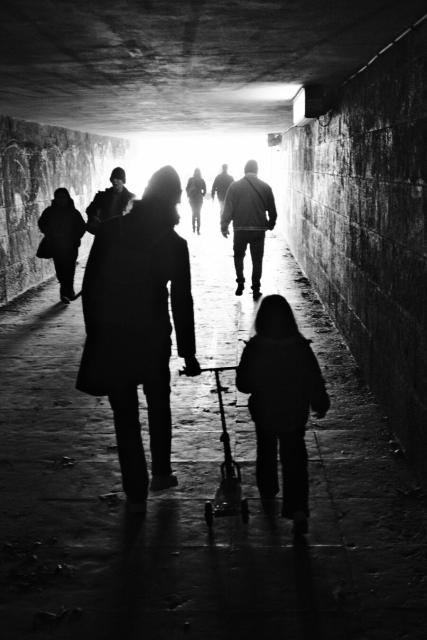 BW picture of the silhouette of my wife and my daughter with her scooter, in an underground passage.