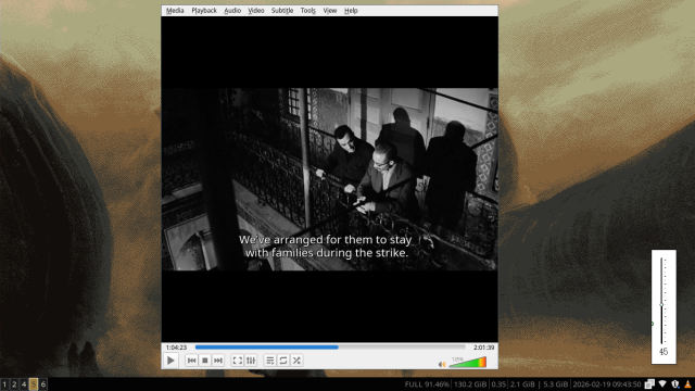 a screenshot of my desktop showing the film The Battle of Algiers playing in VLC, with a little Uxn tool helping with volume control floating at the bottom right of the desktop.