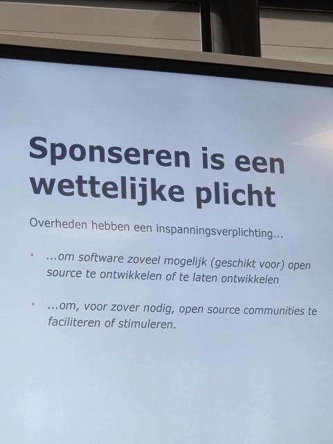"Sponsoring open source is a legal obligation (for the government)" slide on the main screen.