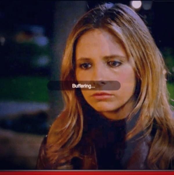Picture of the show, Buffy The Vampire Slayer, with Buffy looking slightly down and to her right with a "Buffering..." message from the streaming service in the middle of the screen.