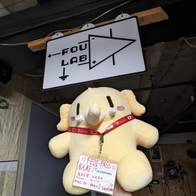 Plushtodon plush toy below the FOULAB hackerspace sign