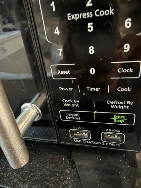 A microwave with two USB charging ports
